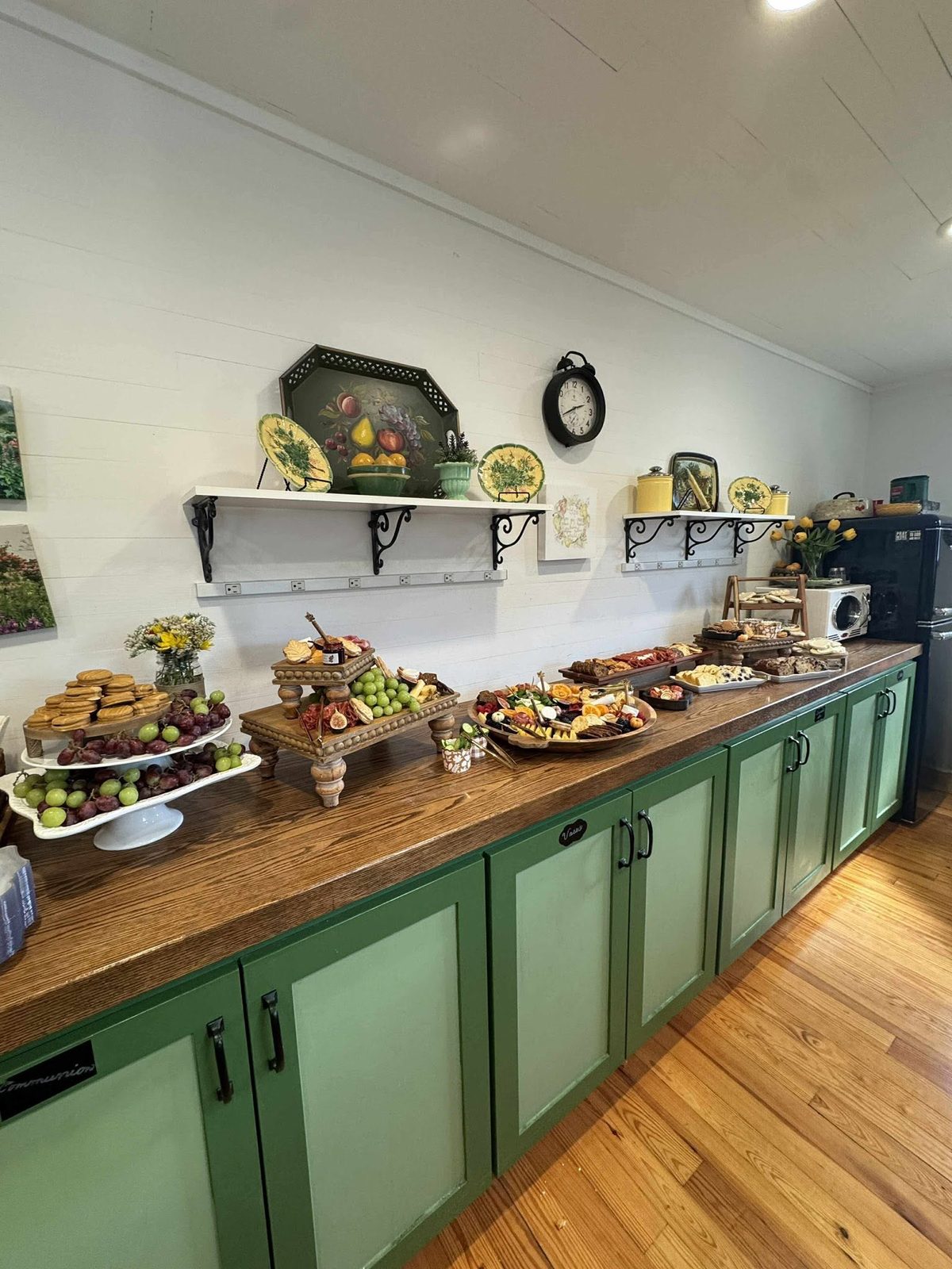 The chapel kitchen counter spread with fruit, cheese, cookies and tulips
